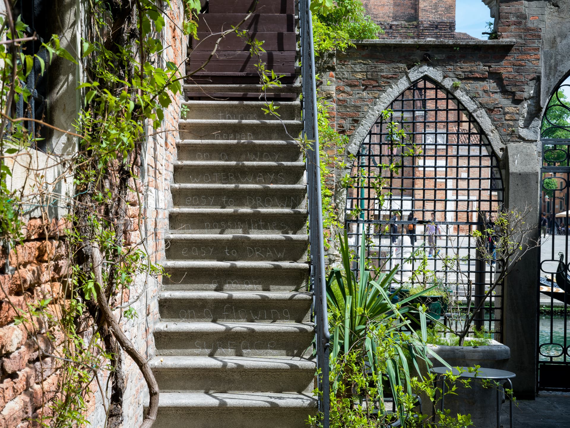 Chalk poem written on stone stairs in Venice
