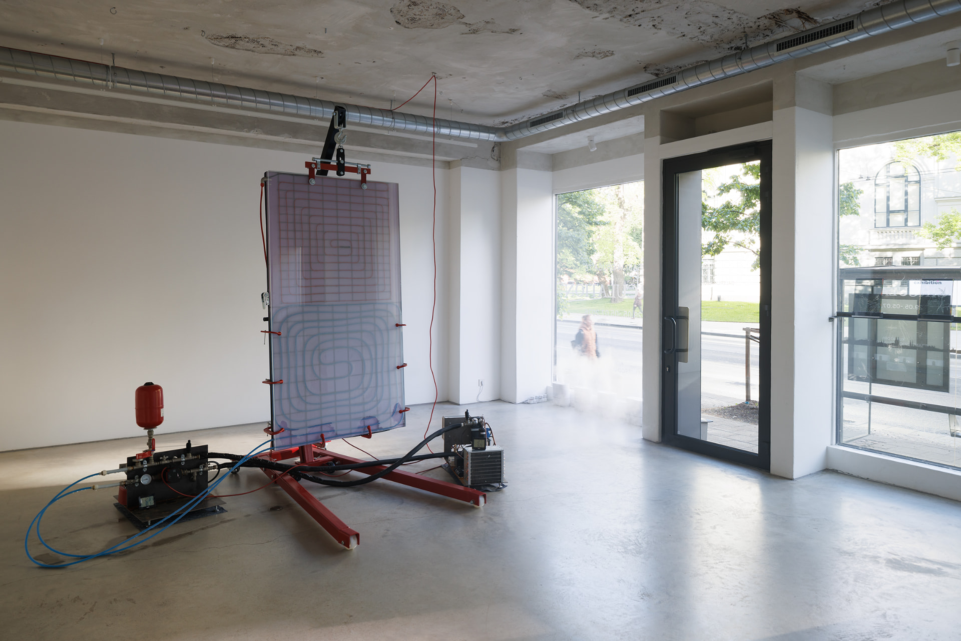 Circulation — the sculpture in the gallery, street windows behind